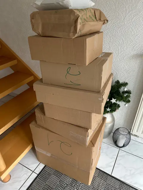 A tower of delivery boxes at the bottom of the stairs