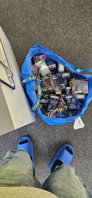 A bag full of Pokémon booster packs and tins