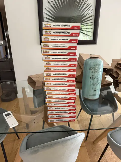 A column of Pokémon First Partner collections on a glass table