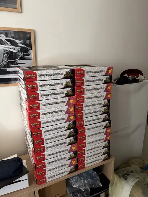 Pokémon collection boxes stacked on a shelf unit